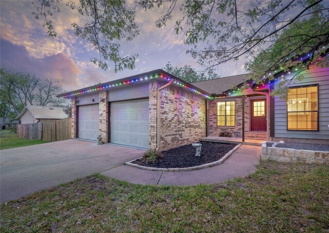 100 Stubblefield Dr, Elgin, TX 78621 - single story home featuring driveway, an attached garage, and brick siding