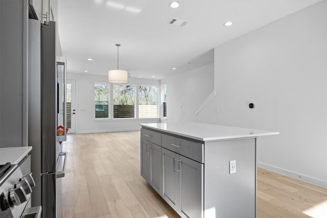2209 Mcfly Pl, Austin, TX 78723 - kitchen featuring gray cabinetry, light wood-type flooring, light countertops, recessed lighting, and decorative light fixtures
