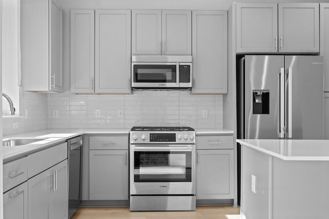 2209 Mcfly Pl, Austin, TX 78723 - kitchen with appliances with stainless steel finishes, light countertops, and backsplash