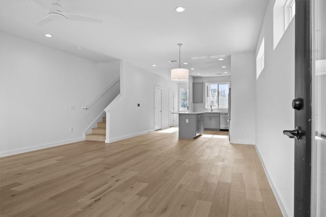 2209 Mcfly Pl, Austin, TX 78723 - unfurnished living room with light wood-style floors, stairway, recessed lighting, and a ceiling fan