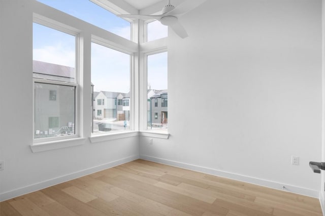 2209 Mcfly Pl, Austin, TX 78723 - empty room featuring healthy amount of natural light, light wood finished floors, a ceiling fan, and baseboards