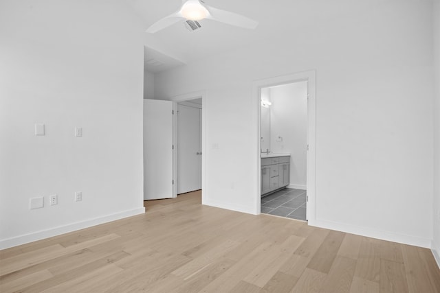 2209 Mcfly Pl, Austin, TX 78723 - unfurnished bedroom with light wood finished floors, ensuite bathroom, baseboards, and a ceiling fan