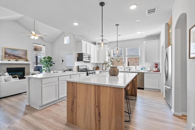 5833 Bianca Dr, Round Rock, TX 78665 - kitchen with stainless steel appliances, a center island, open floor plan, light wood-style flooring, and recessed lighting