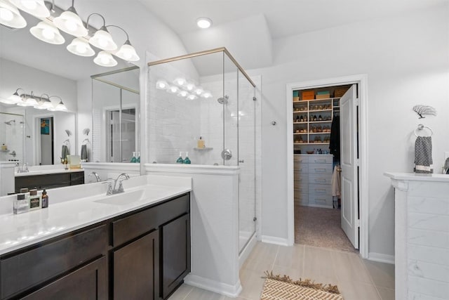 5833 Bianca Dr, Round Rock, TX 78665 - bathroom featuring a shower stall, vanity, a walk in closet, and a chandelier