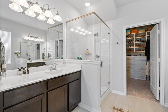 5833 Bianca Dr, Round Rock, TX 78665 - bathroom with a stall shower, vanity, a spacious closet, and a chandelier