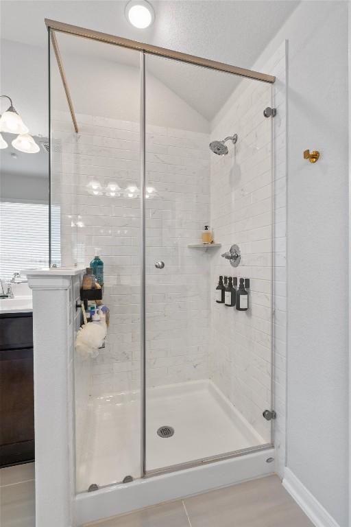 5833 Bianca Dr, Round Rock, TX 78665 - full bathroom featuring a shower stall, vanity, and lofted ceiling