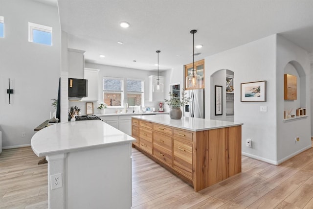 5833 Bianca Dr, Round Rock, TX 78665 - kitchen with stainless steel fridge, light countertops, healthy amount of natural light, light wood-style floors, and recessed lighting