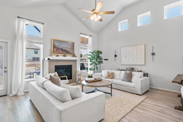 5833 Bianca Dr, Round Rock, TX 78665 - living room featuring ceiling fan, light wood-style floors, high vaulted ceiling, and a fireplace