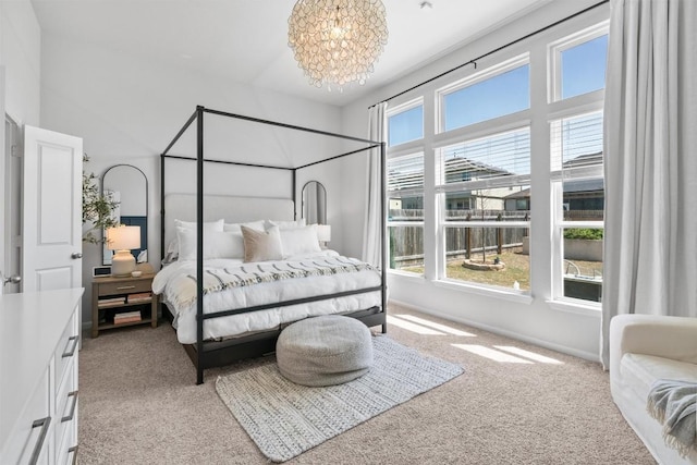 carpeted bedroom featuring a notable chandelier
