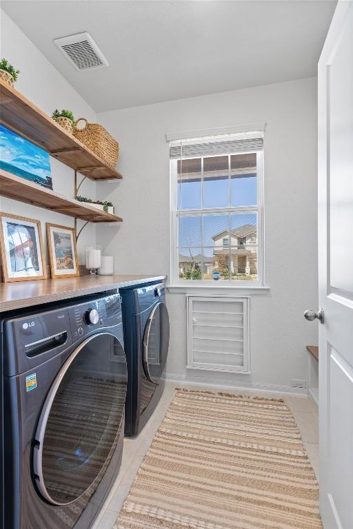 5833 Bianca Dr, Round Rock, TX 78665 - laundry area with washing machine and dryer and light tile patterned floors