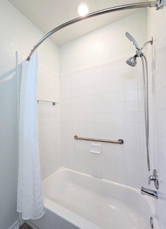 full bathroom with shower / tub combo with curtain