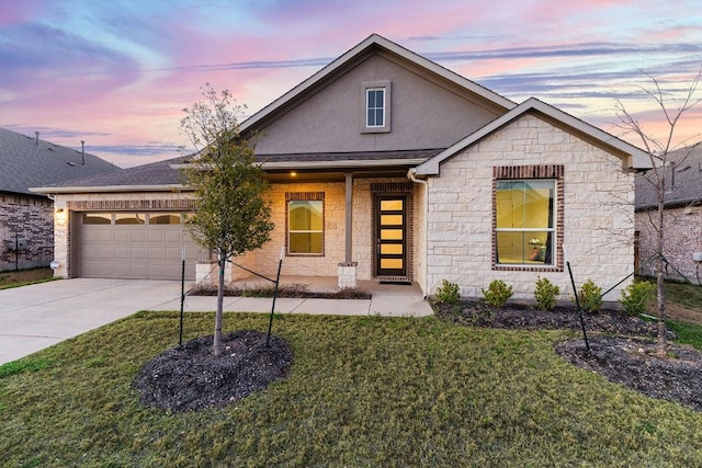 2233 Bravo Pass, Leander, TX 78641 - view of front facade with stone siding, a garage, concrete driveway, and a front yard