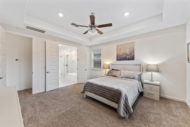 2233 Bravo Pass, Leander, TX 78641 - bedroom with carpet floors, a raised ceiling, baseboards, recessed lighting, and ensuite bath