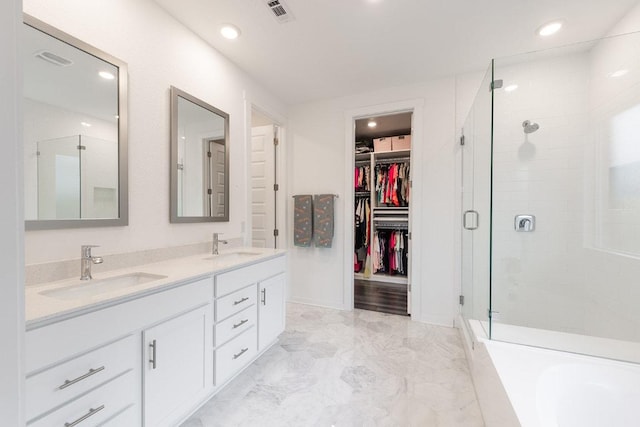 2233 Bravo Pass, Leander, TX 78641 - full bathroom with a shower stall, double vanity, marble finish flooring, a spacious closet, and a garden tub