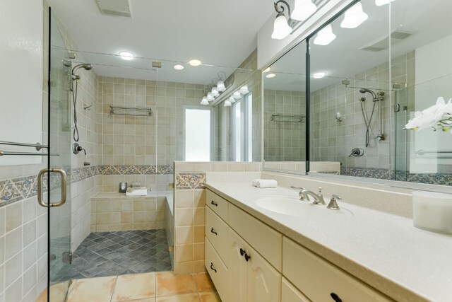 910 Old Stonehedge St, Austin, TX 78746 - full bath with a shower stall, vanity, tile patterned flooring, tile walls, and recessed lighting