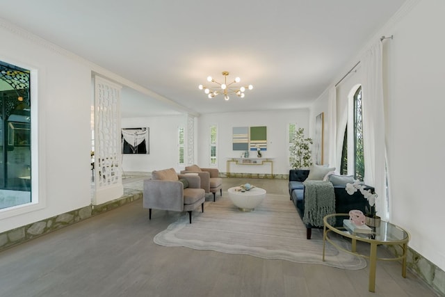 910 Old Stonehedge St, Austin, TX 78746 - living room featuring a chandelier, wood finished floors, and ornamental molding