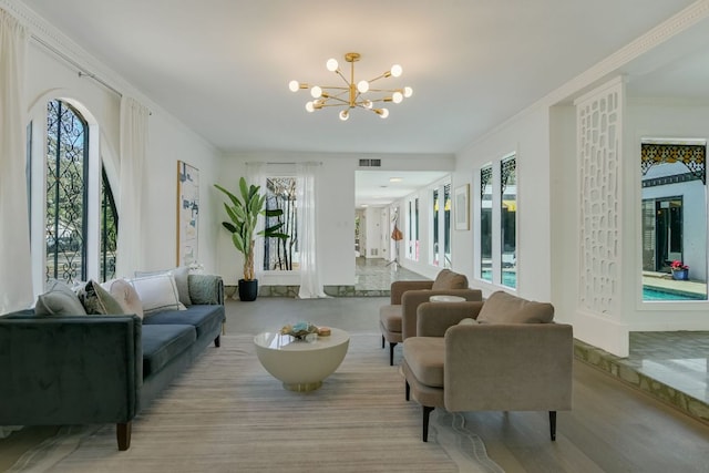 910 Old Stonehedge St, Austin, TX 78746 - living room featuring a chandelier, healthy amount of natural light, and ornamental molding