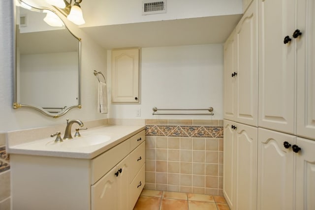 910 Old Stonehedge St, Austin, TX 78746 - bathroom featuring vanity, tile walls, tile patterned flooring, and wainscoting