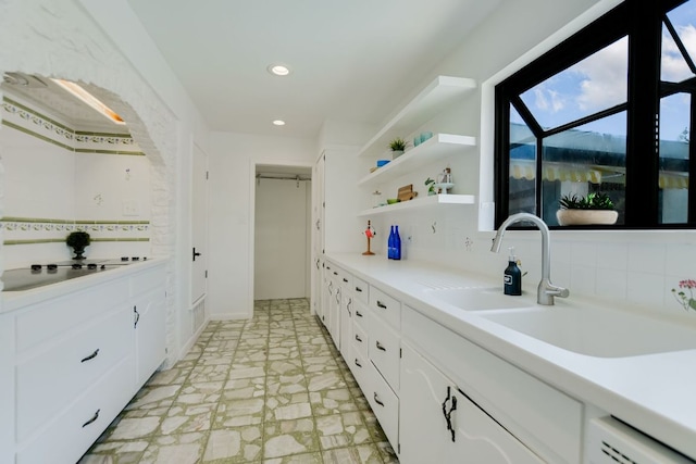 910 Old Stonehedge St, Austin, TX 78746 - kitchen featuring a sink, decorative backsplash, white cabinets, light countertops, and recessed lighting