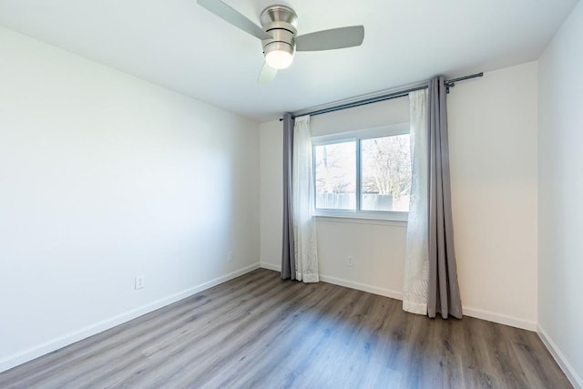 12303 Bainbridge Ln, Austin, TX 78750 - empty room with wood finished floors, a ceiling fan, and baseboards