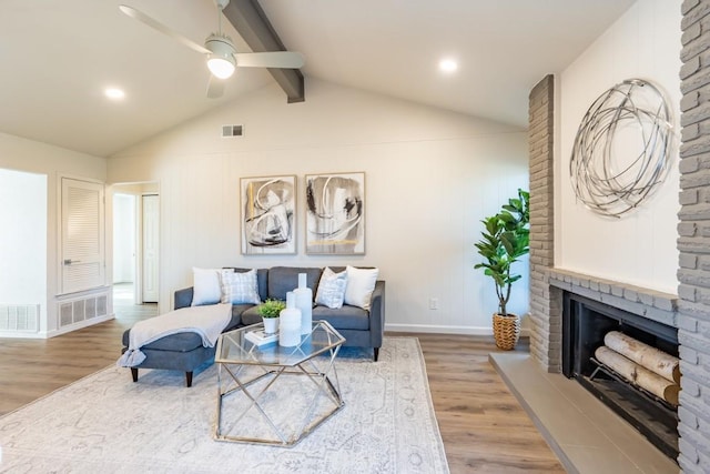 12303 Bainbridge Ln, Austin, TX 78750 - living room with wood finished floors, a ceiling fan, a large fireplace, and baseboards