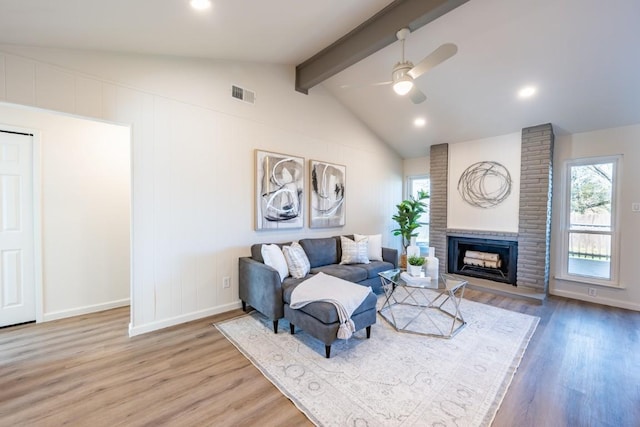 12303 Bainbridge Ln, Austin, TX 78750 - living area featuring a ceiling fan, wood finished floors, baseboards, a brick fireplace, and recessed lighting