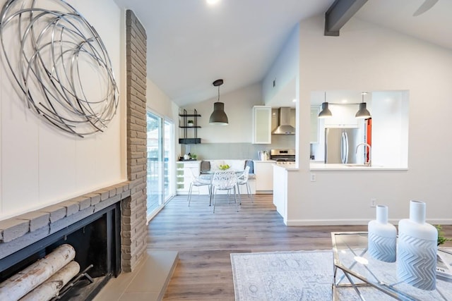 12303 Bainbridge Ln, Austin, TX 78750 - living area with light wood-type flooring, a brick fireplace, and baseboards