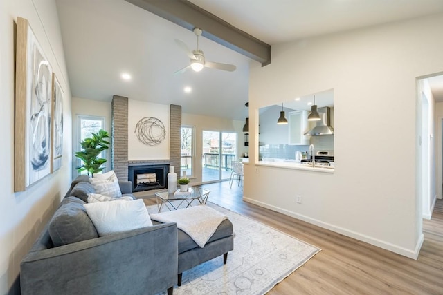 12303 Bainbridge Ln, Austin, TX 78750 - living room featuring a fireplace, ceiling fan, light wood-type flooring, and baseboards