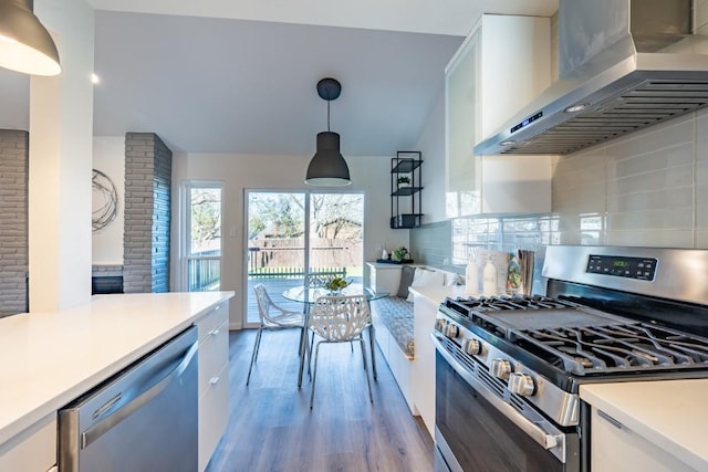 12303 Bainbridge Ln, Austin, TX 78750 - kitchen with stainless steel appliances, wall chimney range hood, light wood-type flooring, light countertops, and tasteful backsplash