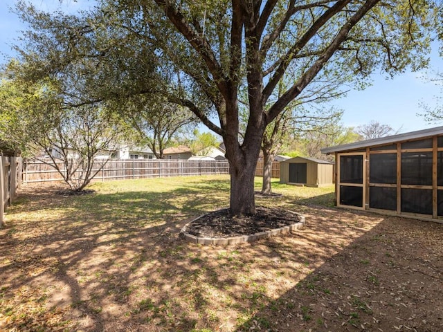 view of yard featuring a fenced backyard, a shed, and an outdoor structure