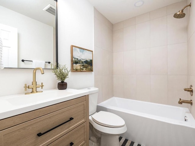 full bath with visible vents, toilet, vanity, and bathing tub / shower combination