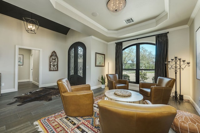 3012 Driftwood Ln, Horseshoe Bay, TX 78657 - living area featuring a tray ceiling, baseboards, wood finished floors, a chandelier, and arched walkways