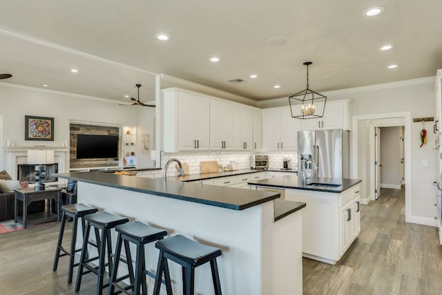 3012 Driftwood Ln, Horseshoe Bay, TX 78657 - kitchen featuring high end refrigerator, dark countertops, recessed lighting, a sink, and wood finished floors
