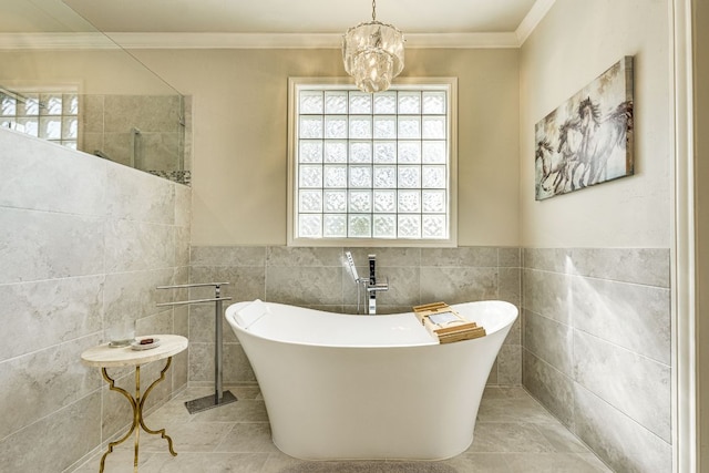 3012 Driftwood Ln, Horseshoe Bay, TX 78657 - bathroom with tile walls, a freestanding bath, crown molding, tile patterned flooring, and a chandelier