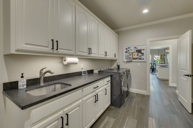 3012 Driftwood Ln, Horseshoe Bay, TX 78657 - laundry room featuring separate washer and dryer, cabinet space, crown molding, baseboards, and dark wood finished floors