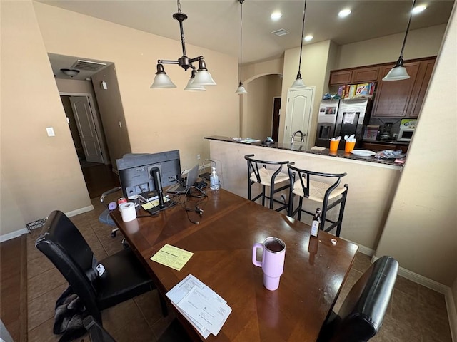 2316 Dovetail St, Pflugerville, TX 78660 - tiled dining space with arched walkways, an office area, and recessed lighting