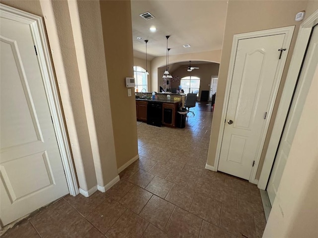 2316 Dovetail St, Pflugerville, TX 78660 - corridor with arched walkways, dark tile patterned flooring, and recessed lighting