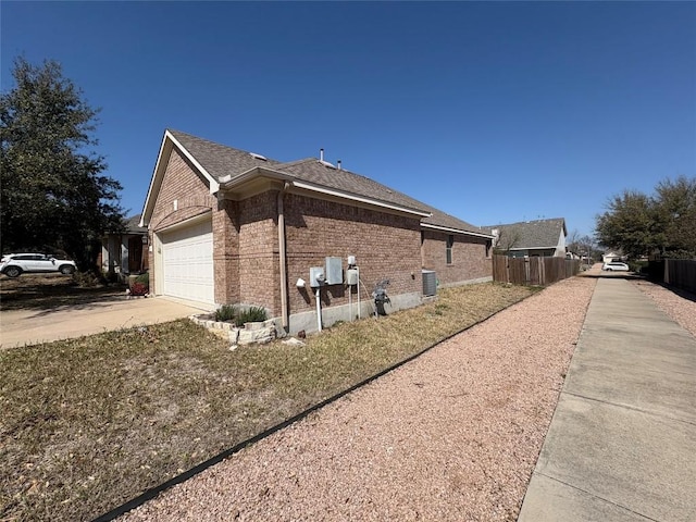 2316 Dovetail St, Pflugerville, TX 78660 - view of home's exterior with brick siding, concrete driveway, an attached garage, and a shingled roof