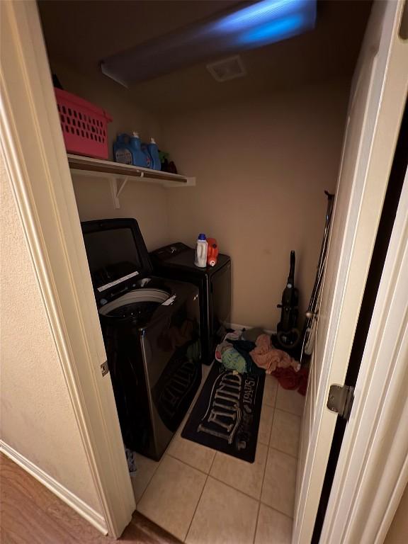 2316 Dovetail St, Pflugerville, TX 78660 - washroom featuring tile patterned floors and separate washer and dryer