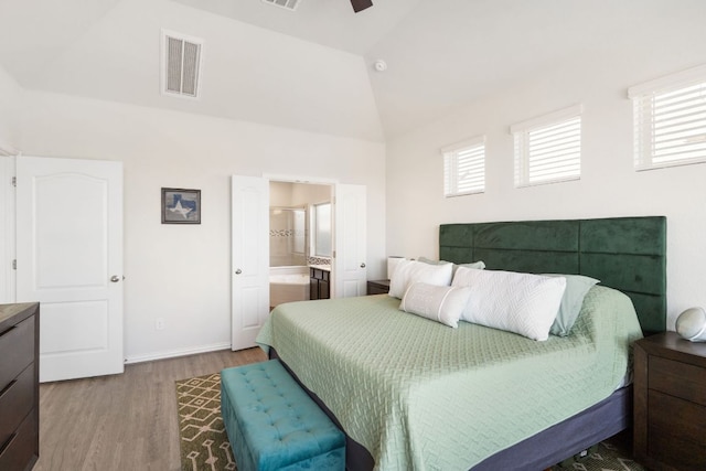 277 Biscayne Bay Bnd, Kyle, TX 78640 - bedroom featuring wood finished floors, multiple windows, high vaulted ceiling, ensuite bathroom, and a ceiling fan