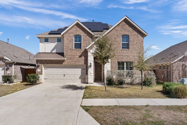 277 Biscayne Bay Bnd, Kyle, TX 78640 - traditional home featuring brick siding, a garage, concrete driveway, a front lawn, and solar panels