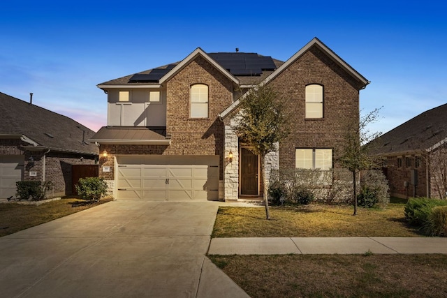 277 Biscayne Bay Bnd, Kyle, TX 78640 - traditional-style house with brick siding, driveway, a garage, solar panels, and a front lawn