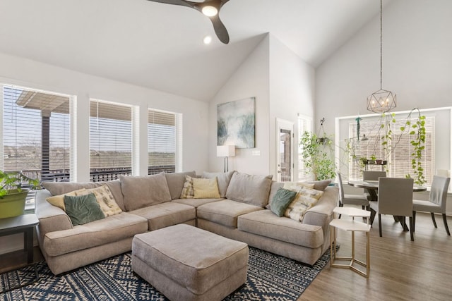 277 Biscayne Bay Bnd, Kyle, TX 78640 - living room with high vaulted ceiling, a chandelier, wood finished floors, and a ceiling fan