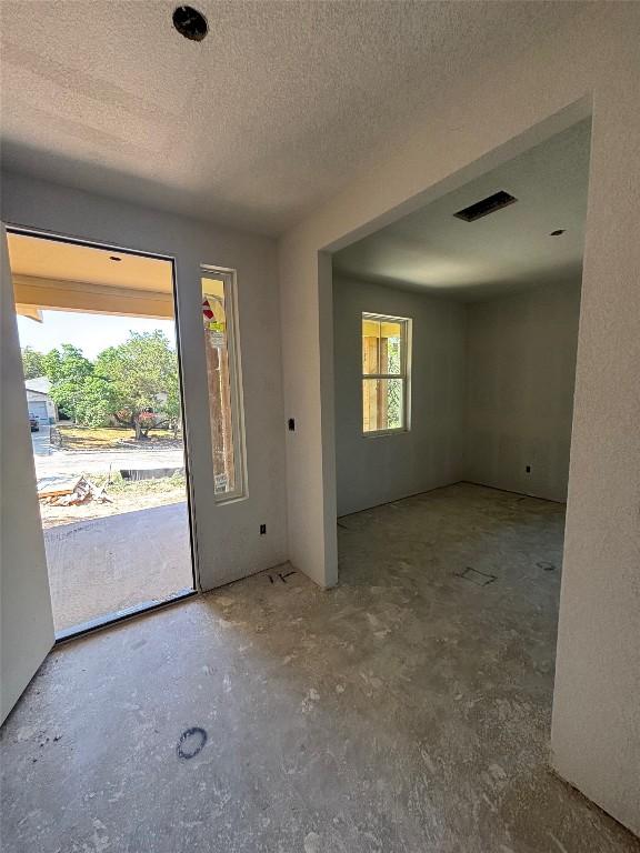20110 Lee Ln, Lago Vista, TX 78645 - foyer with visible vents, a textured ceiling, and concrete flooring