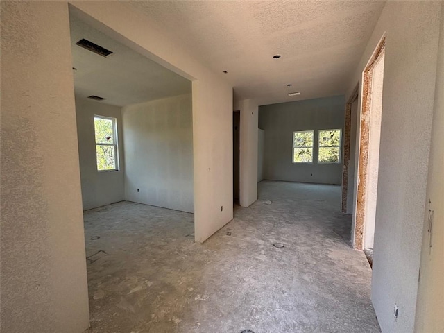 20110 Lee Ln, Lago Vista, TX 78645 - empty room featuring a textured wall, visible vents, and a textured ceiling