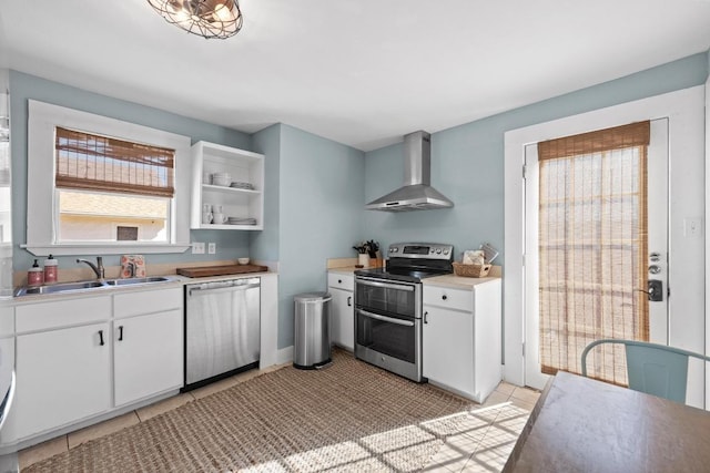 1407 S Myrtle St, Georgetown, TX 78626 - kitchen with appliances with stainless steel finishes, wall chimney exhaust hood, a sink, white cabinets, and light countertops