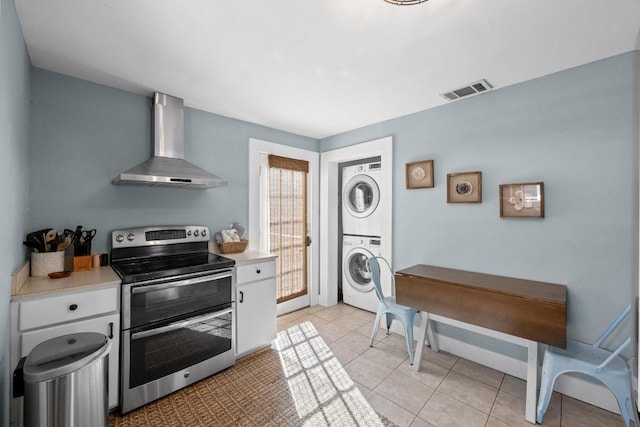 1407 S Myrtle St, Georgetown, TX 78626 - kitchen with double oven range, stacked washer / dryer, wall chimney range hood, and light countertops