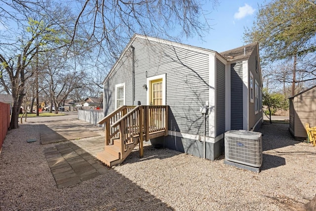 1407 S Myrtle St, Georgetown, TX 78626 - rear view of house with central AC and fence