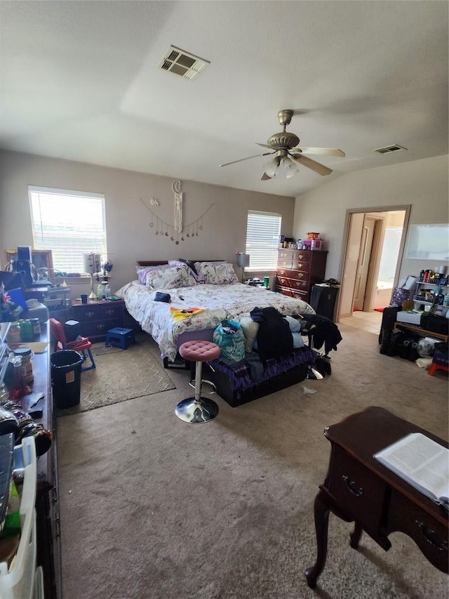 bedroom with carpet floors, visible vents, and multiple windows