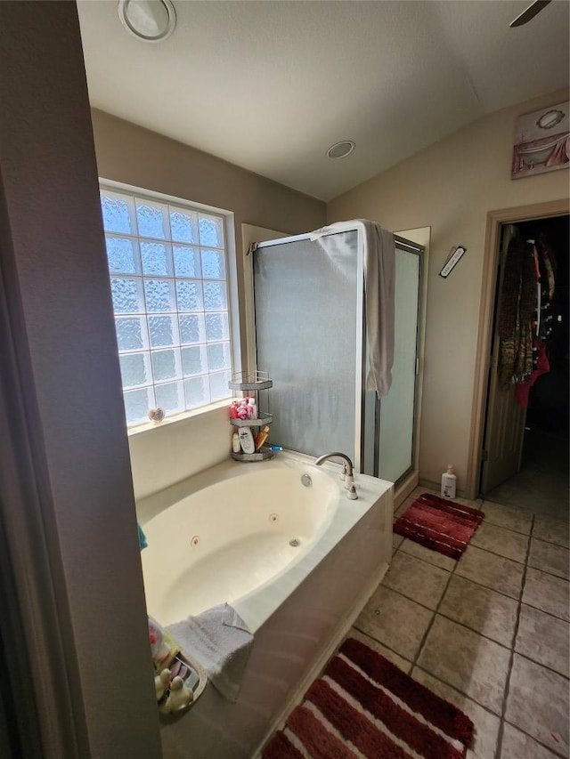 full bath featuring tile patterned flooring, a shower stall, a tub with jets, and lofted ceiling